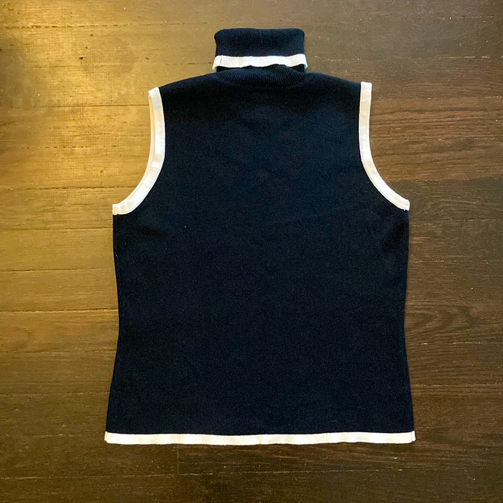 Sleeveless black and white knit turtleneck.